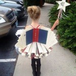 Little girl dressed as a book full of stories to be told